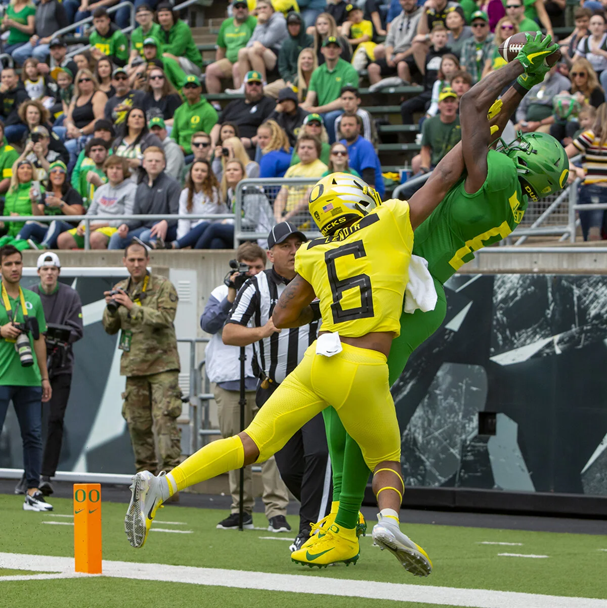  Mighty Oregon wide receiver Juwan Johnson (6) out reaches Fighting Ducks corner back Deommodore Lenoir (6) for a touchdown reception. More than 35,000 fans turned out for the University of Oregon's annual spring football game. Mighty Oregon defeated
