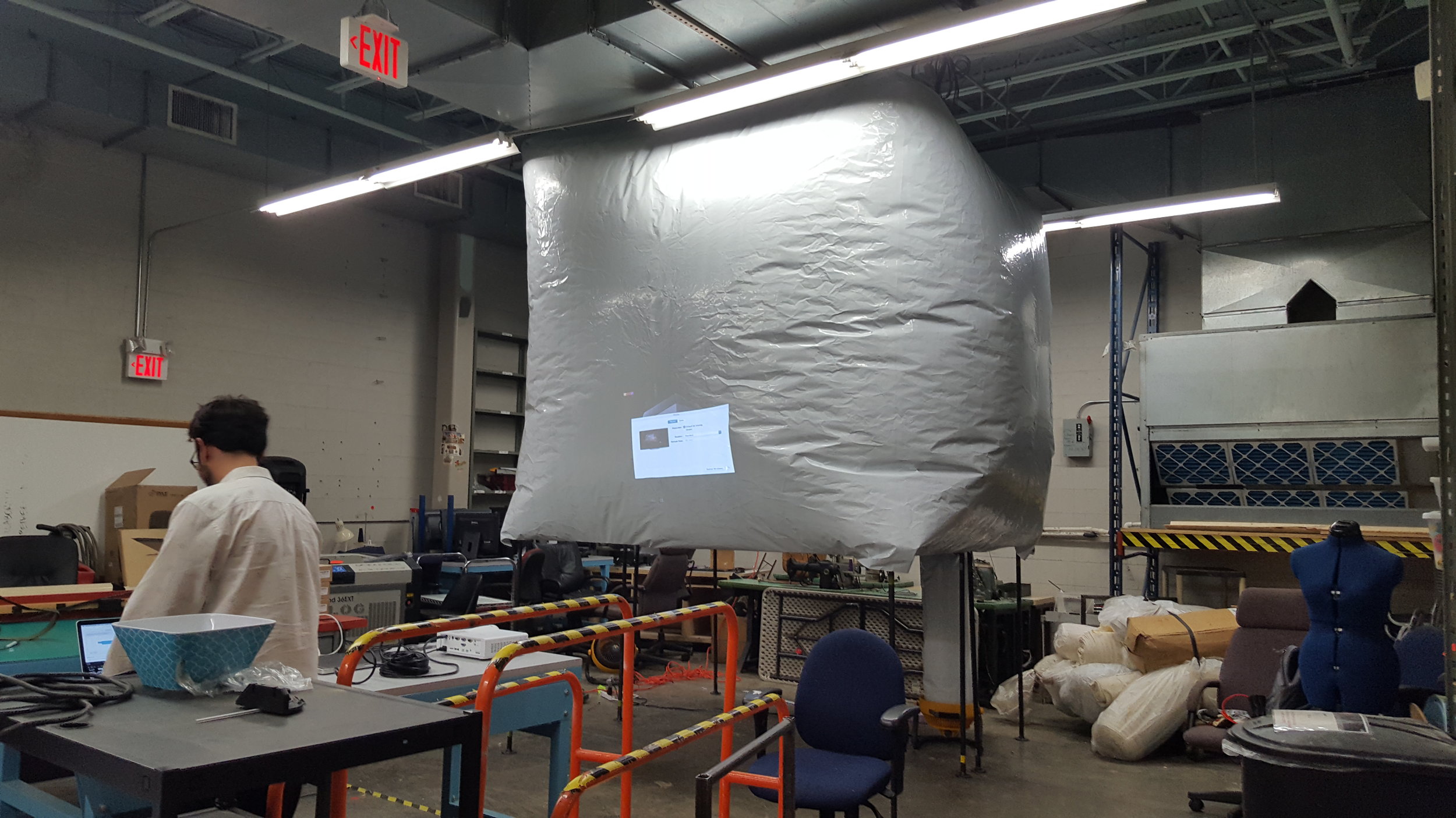 Based on what we heard, we made Story Ship, a four-channel projection screen that featured residents' stories. We worked with graphic designers, fabricators, and videographers. We took woodworking classes to build the installation. 