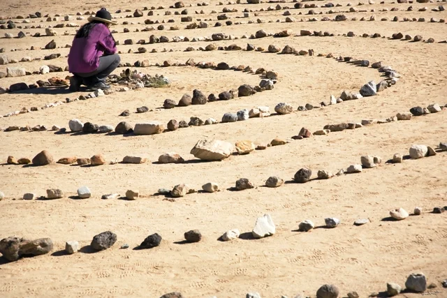 A visitor in the center of the Joshua Tree labyrinth