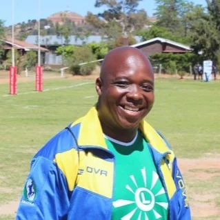 Coach Roy Nyasha Zhou Roy has been coaching rugby in Lesotho since 2012. As well as co-developing the Lesotho Rugby Academy syllabus and delivering it in over 50 schools, Roy established the Maseru Warriors Rugby Club and coaches the Lesotho national team, the Likoatola (Stallions). He is World Rugby Level 1 qualified. Roy previously worked as an accountant. He is a pastor, and is trained in topics such as HIV awareness, gender and health.