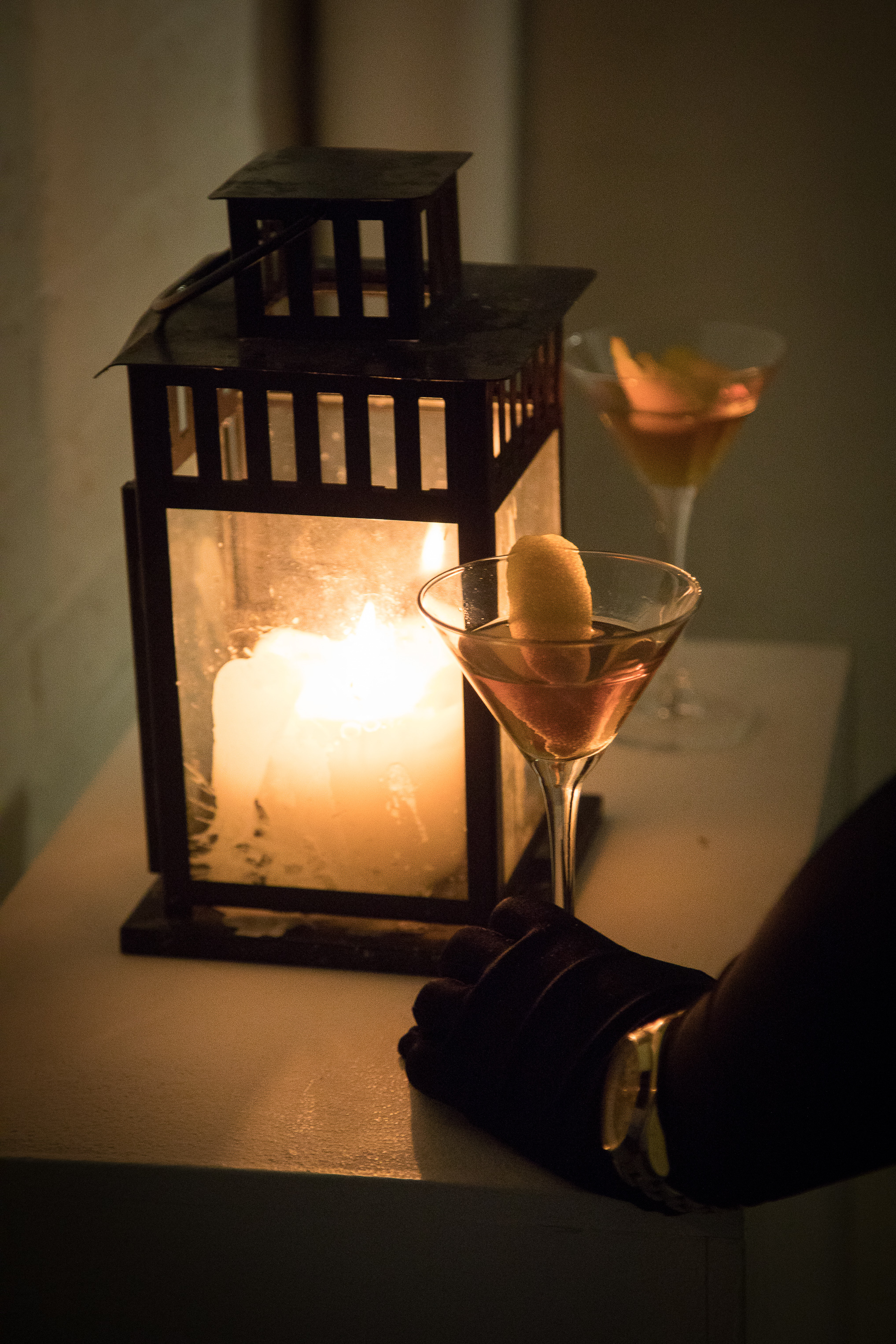 Cocktail glasses, evening gloves and a candle lantern