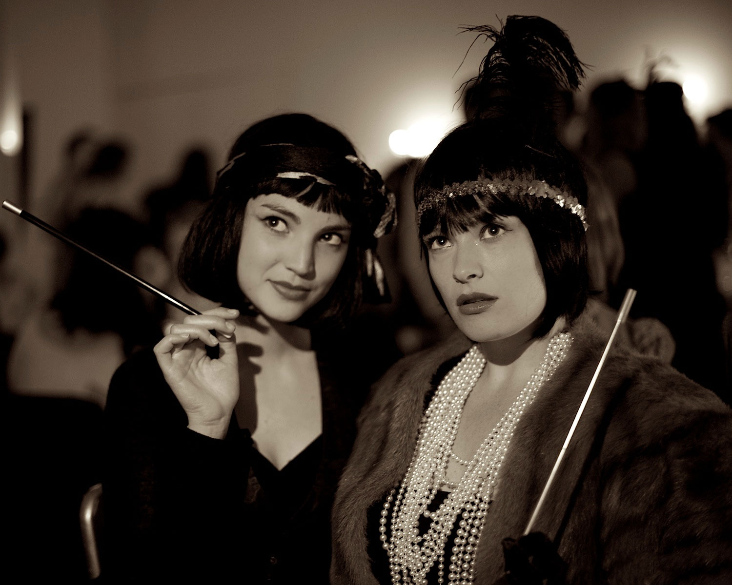 Two flappers with black bobs and long cigarette holders