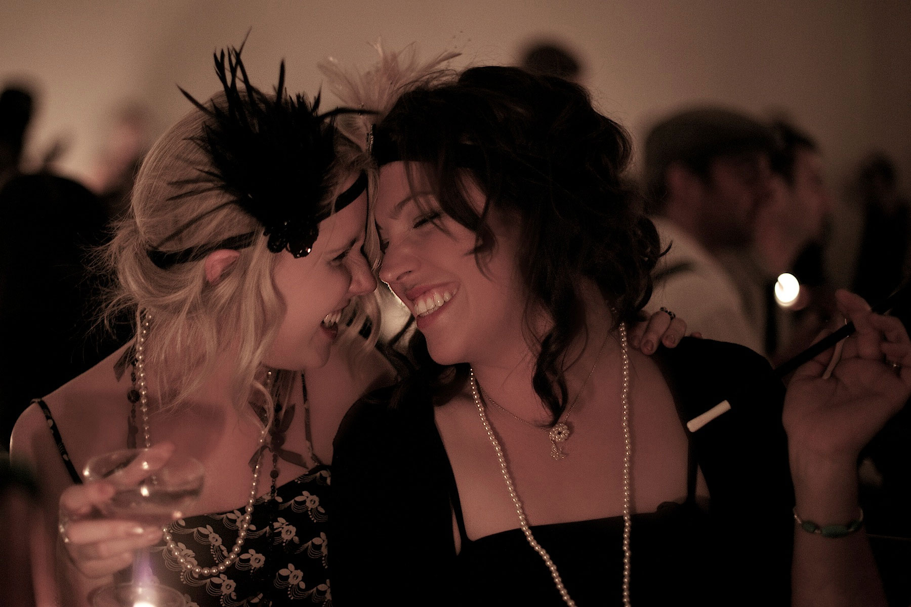 Two women in flapper costumes embracing