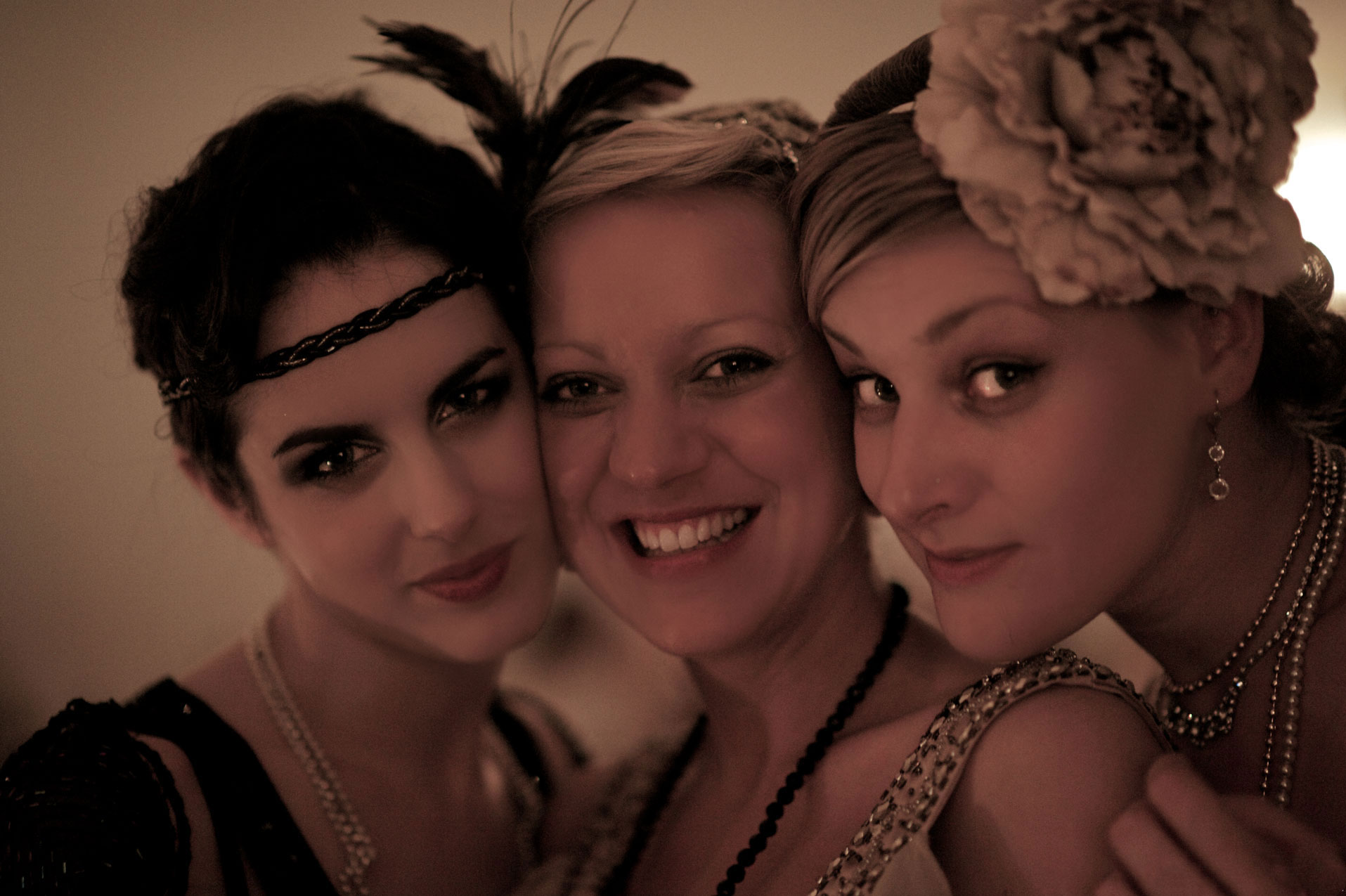 Three flapper ladies cheek to cheek