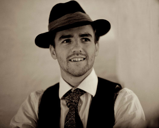 Young man in a tie and fedora hat