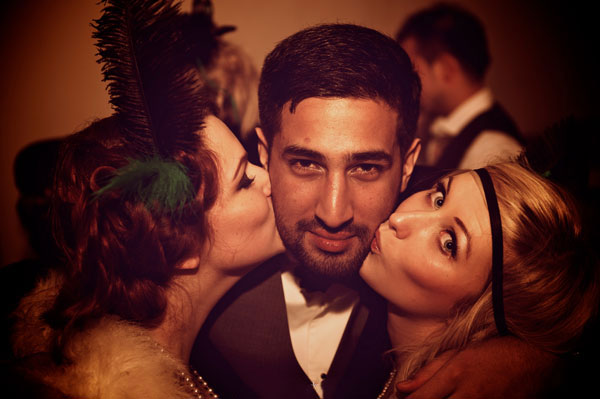 Man being kissed by two women