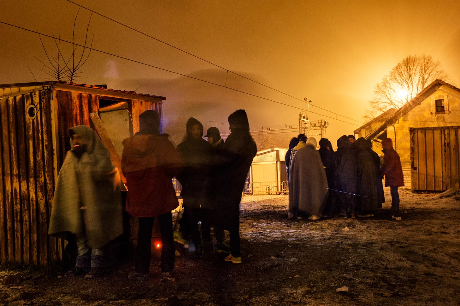  Syrian and Afghan youths protect themselves from the cold with bonfires that populated the platform of the train station of Presevo, Serbia, January 2016. At nightfall, the temperatures plummet and in the tents, there is only room for women and chil