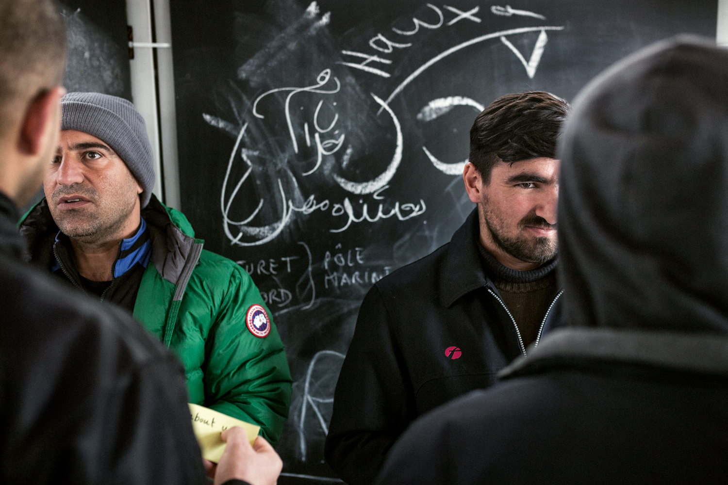  A group of Kurdish refugees attends an English class in the new camp of Grande-Synthe, France, March 2016. Learning English keeps alive the hope of one day crossing the channel and to begin a new life. 