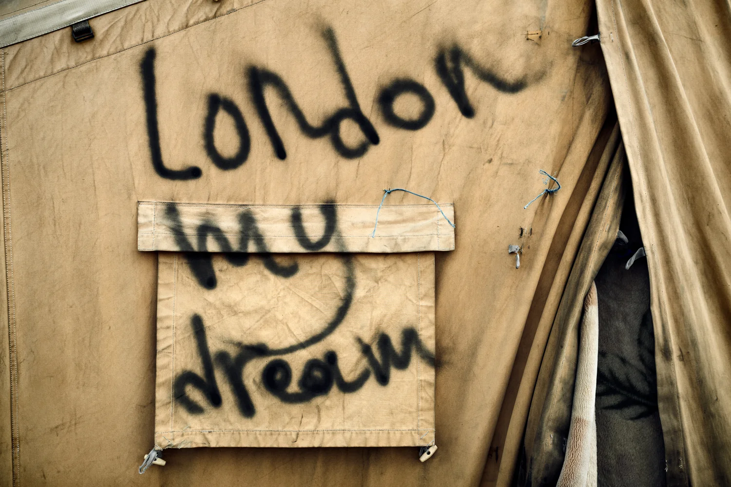  Graffiti at the entrance of a tent in Calais Jungle, France, March 2016. 