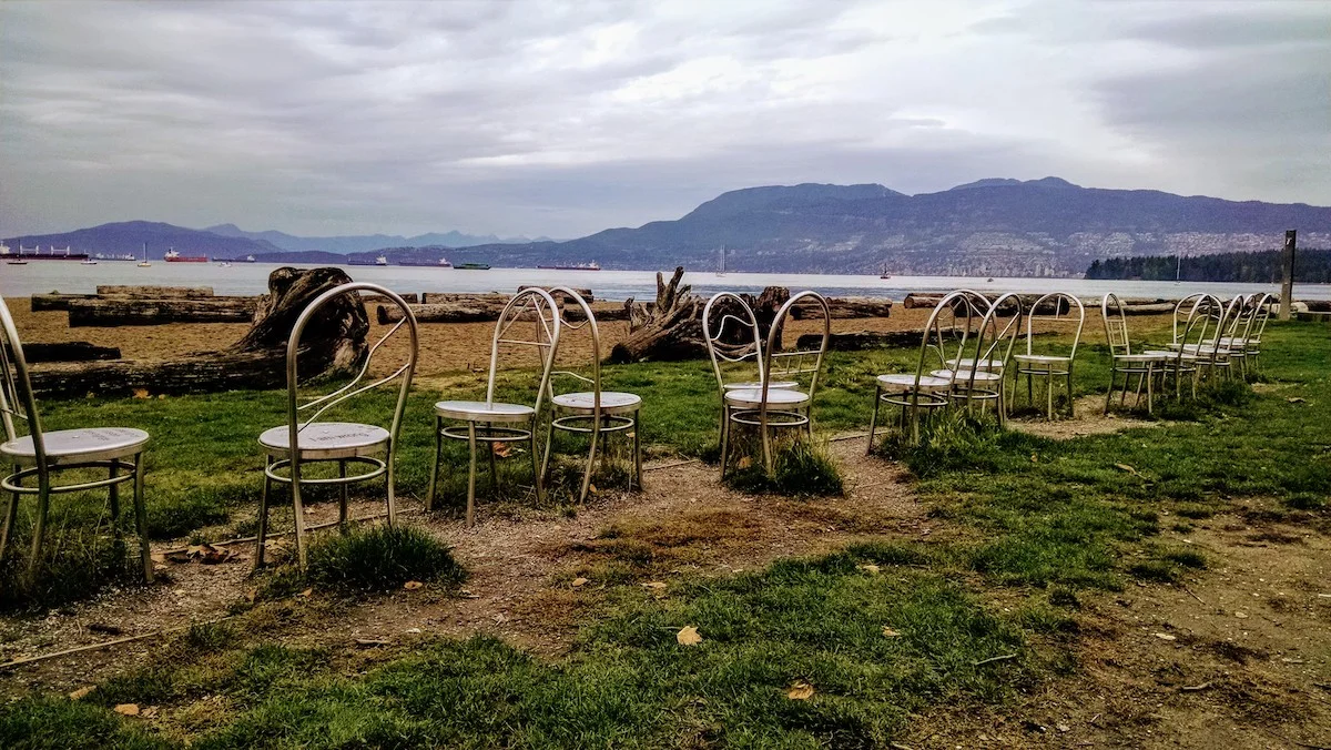 An art installation setup along Kitsilano Beach on a cloudy day
