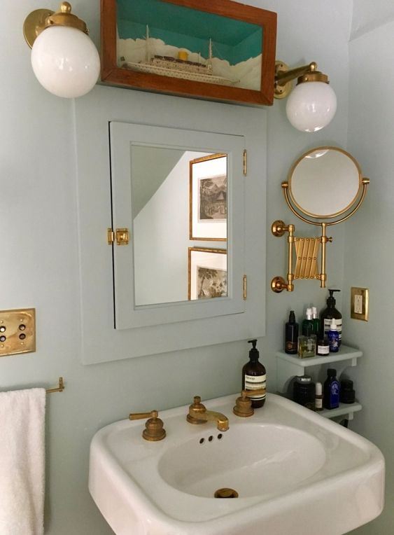 This bathroom is another great example of how consistency can go a long way in design. For example, they could have just painted the walls and not the mirror cabinet trim and wall shelves. By tying them together with one cohesive color, the wall feels complete instead of color-blocked. They also made sure each fixture is in the same gold finish, adding that little extra layer of harmony.