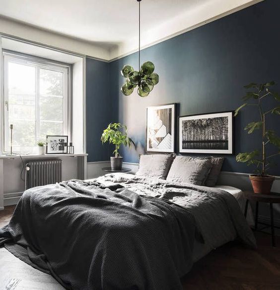 Shades of gray and blue set the mood for sleep in this bedroom .