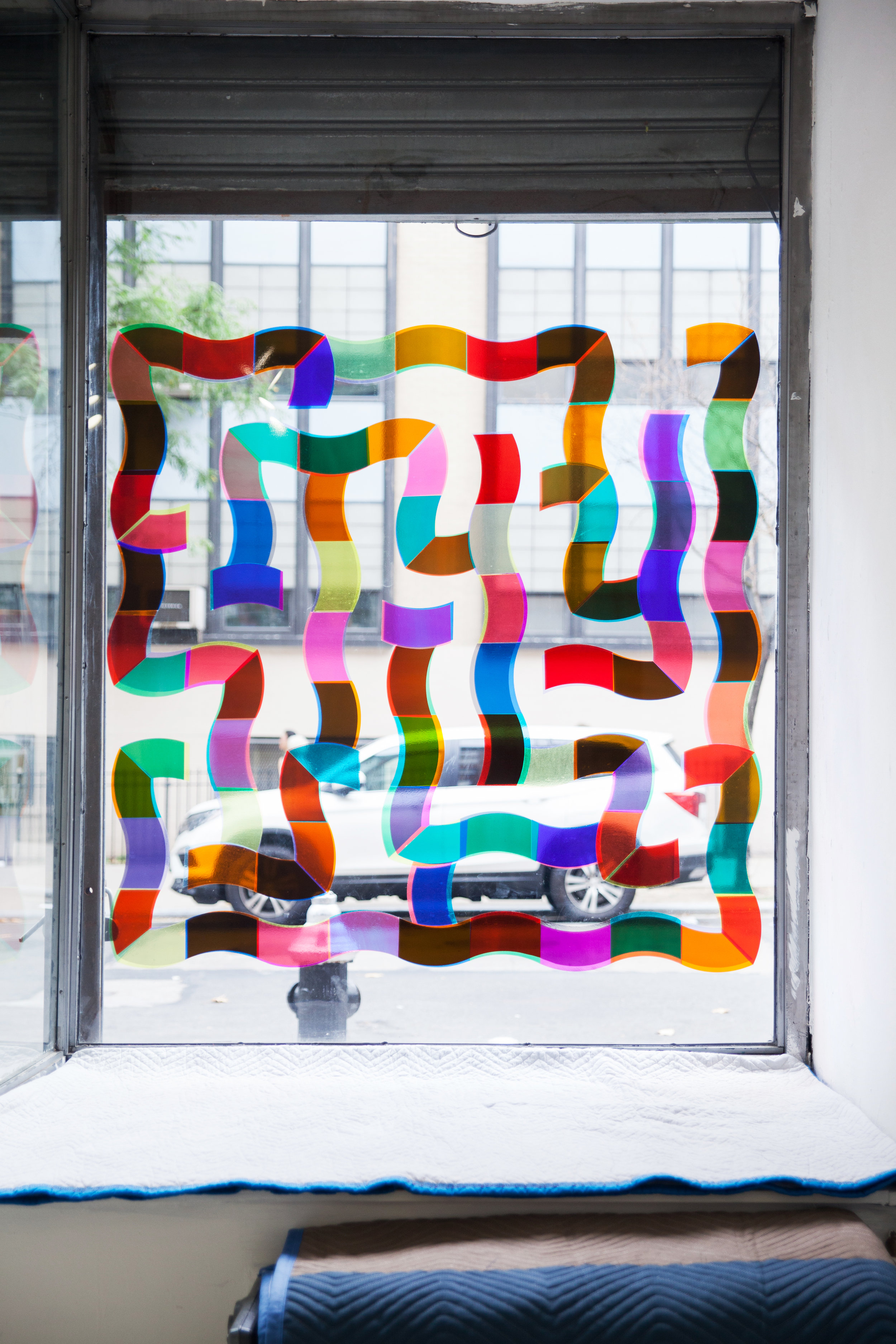   Double Trap ,  Single Use  2018 Colored transparent plastic sheets on glass Approx. 54 x 54 inches 