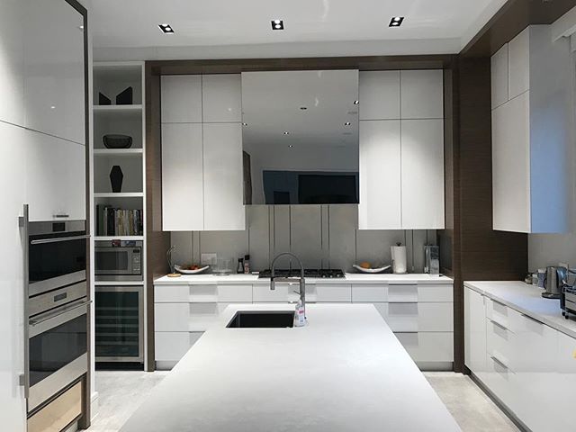 Stainless steel mirror finish hood by @camfab_custom_metal high gloss white doors painted in house with walnut frame. #Cabinetry #cabinetrydesign #cabinetryinstallation #houzz #cabinetryhardware #interiordesign #decor #cabinetrysolutions #Kitchen #ki