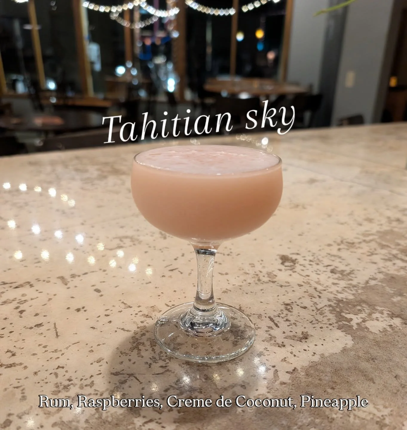 Escape to Tahitian Sky 🌴 White rum, raspberry, pineapple, and cr&egrave;me de coconut&mdash;basically a vacation in a glass. Close your eyes and pretend you're anywhere but here (we won't judge).