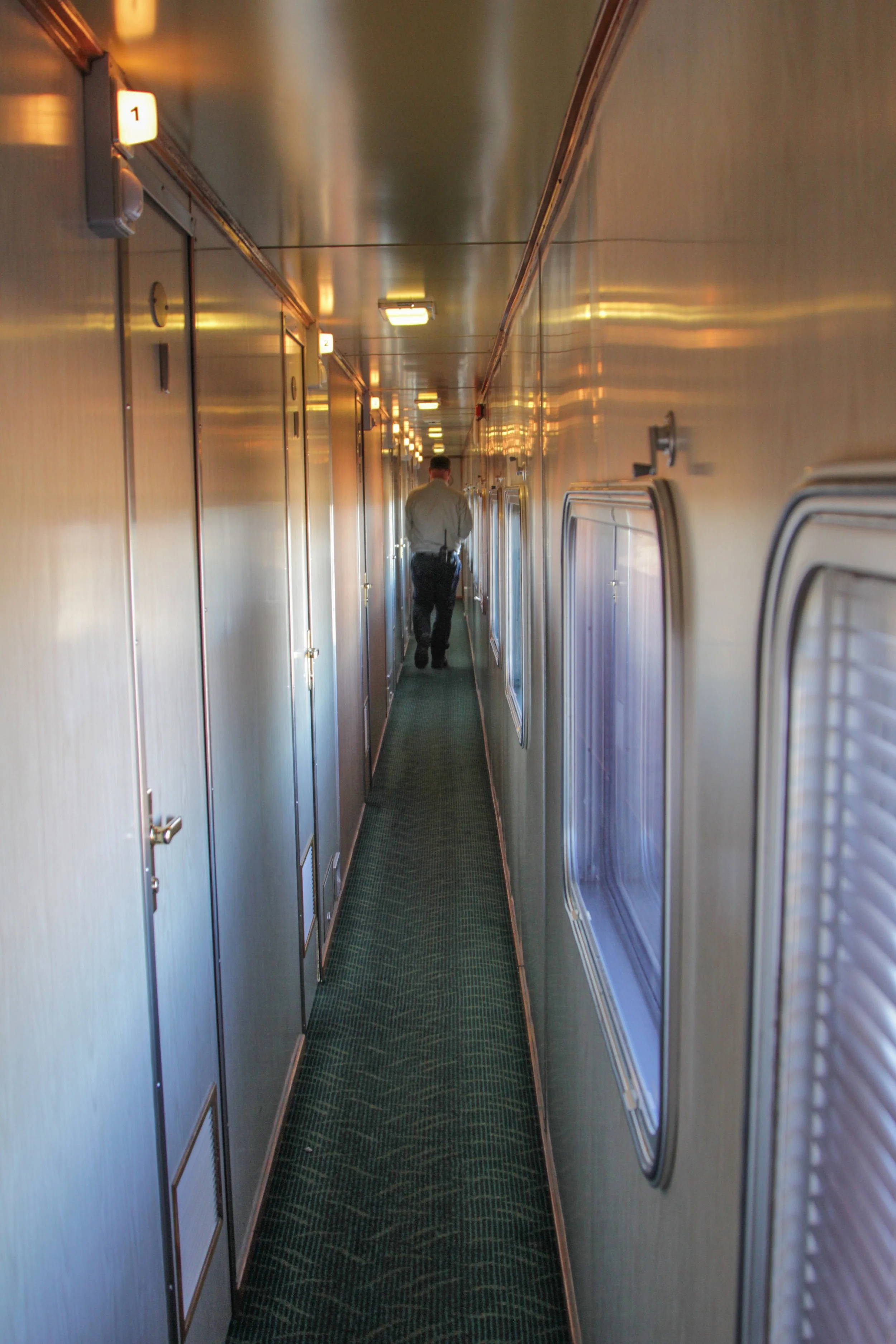 Narrow train corridor with one person