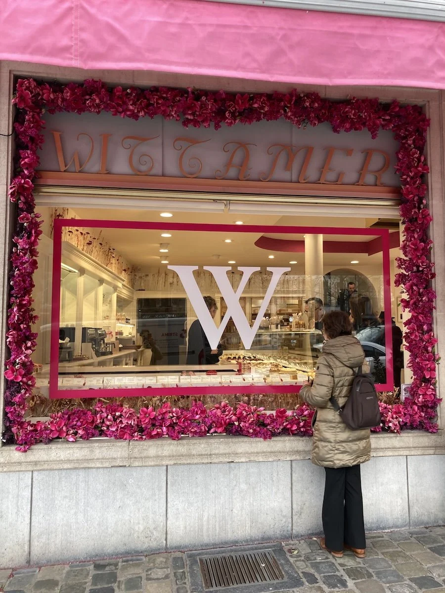 Woman standing outside pink shop