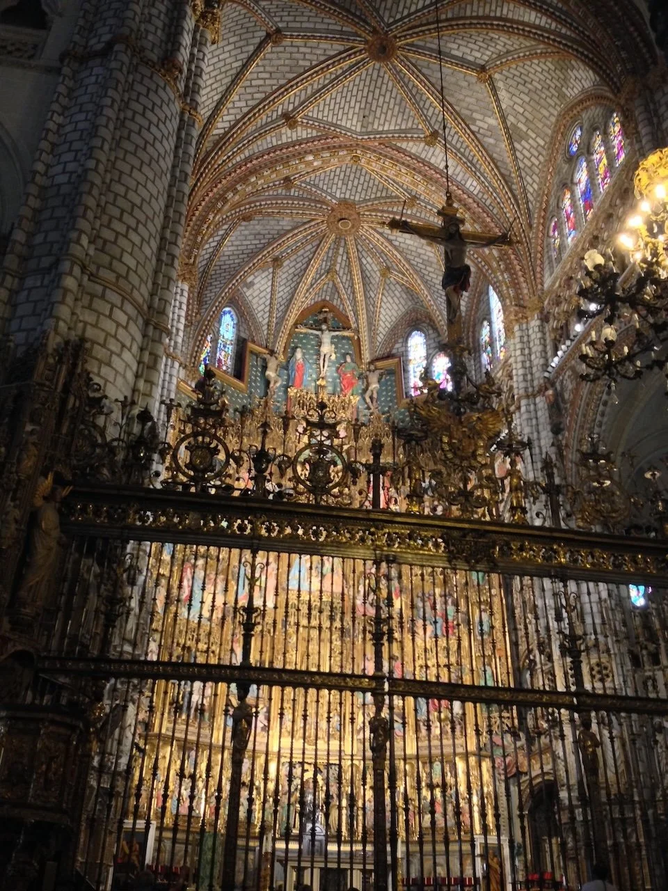 Interior of church, Gothic altarpiece seen behind bars