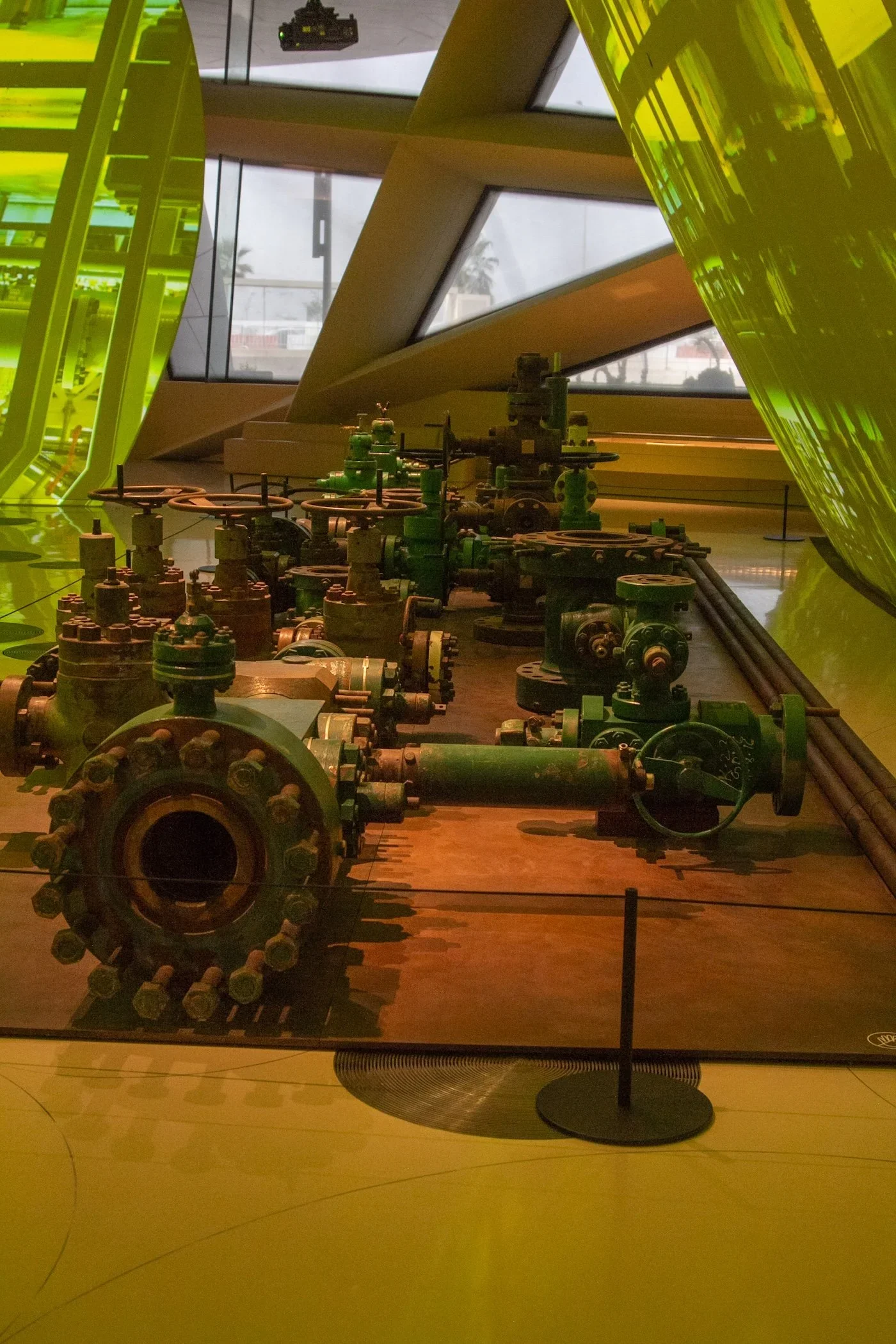 Industrial machinery on display in museum in green lighting