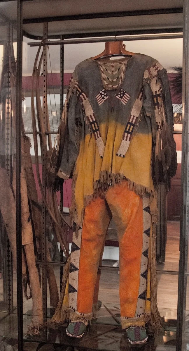 Leather trousers and poncho on display