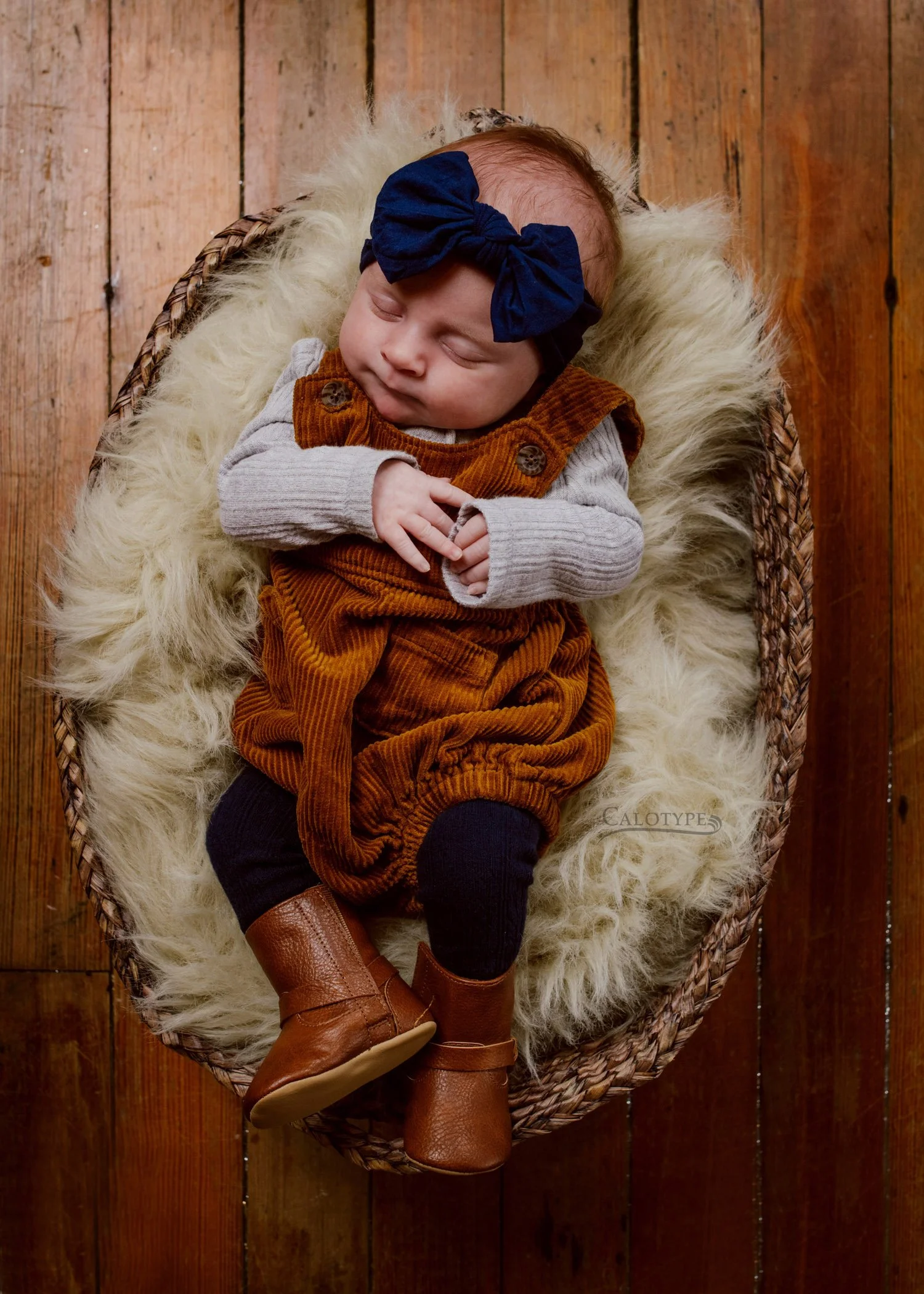 newborn baby girl sleeping in a basket