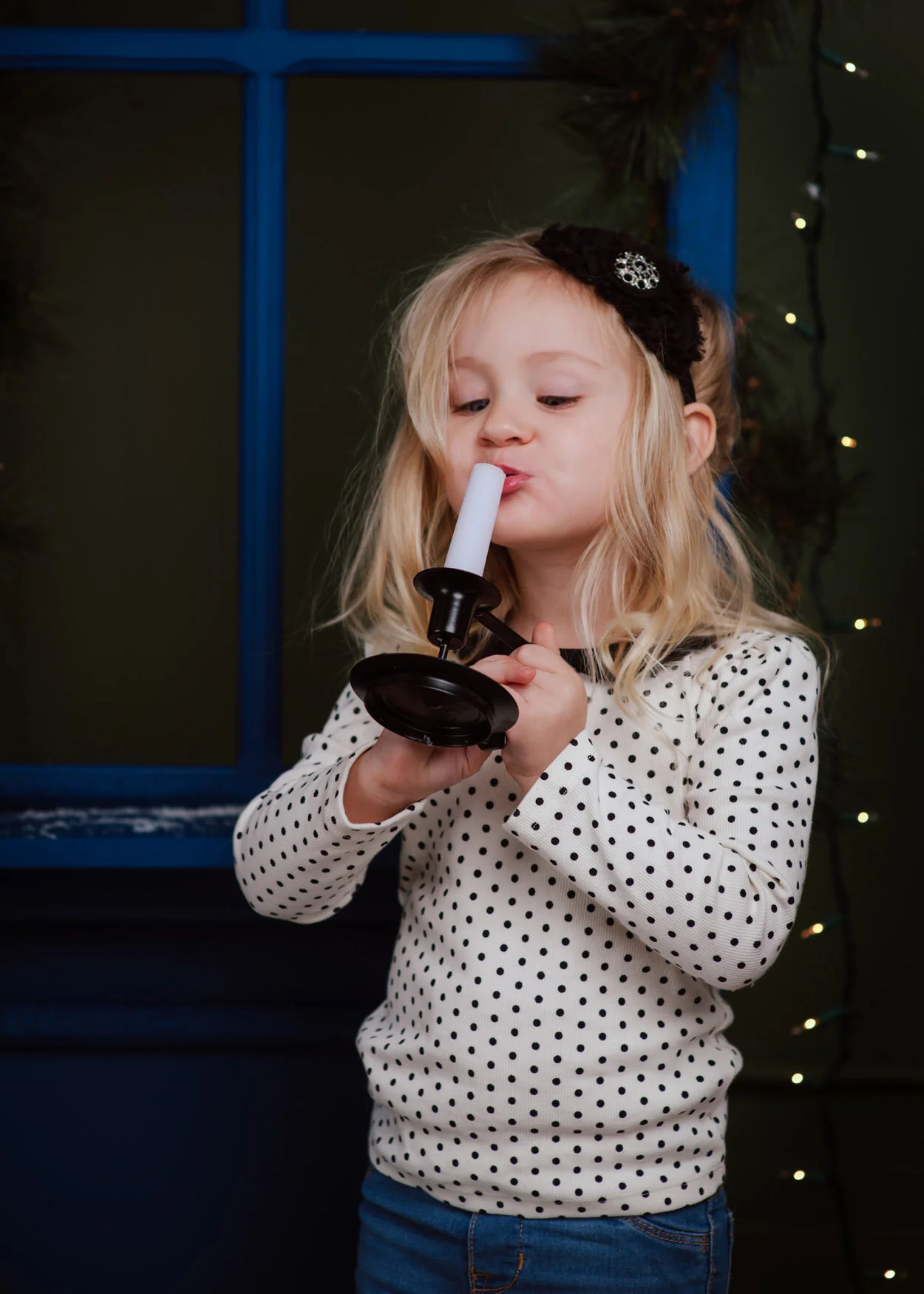 The candle wasn’t really lit- the flame was photoshopped.  Here she is, pretending to blow it out.