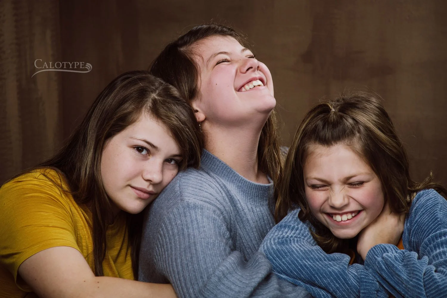sisters laughing and hugging