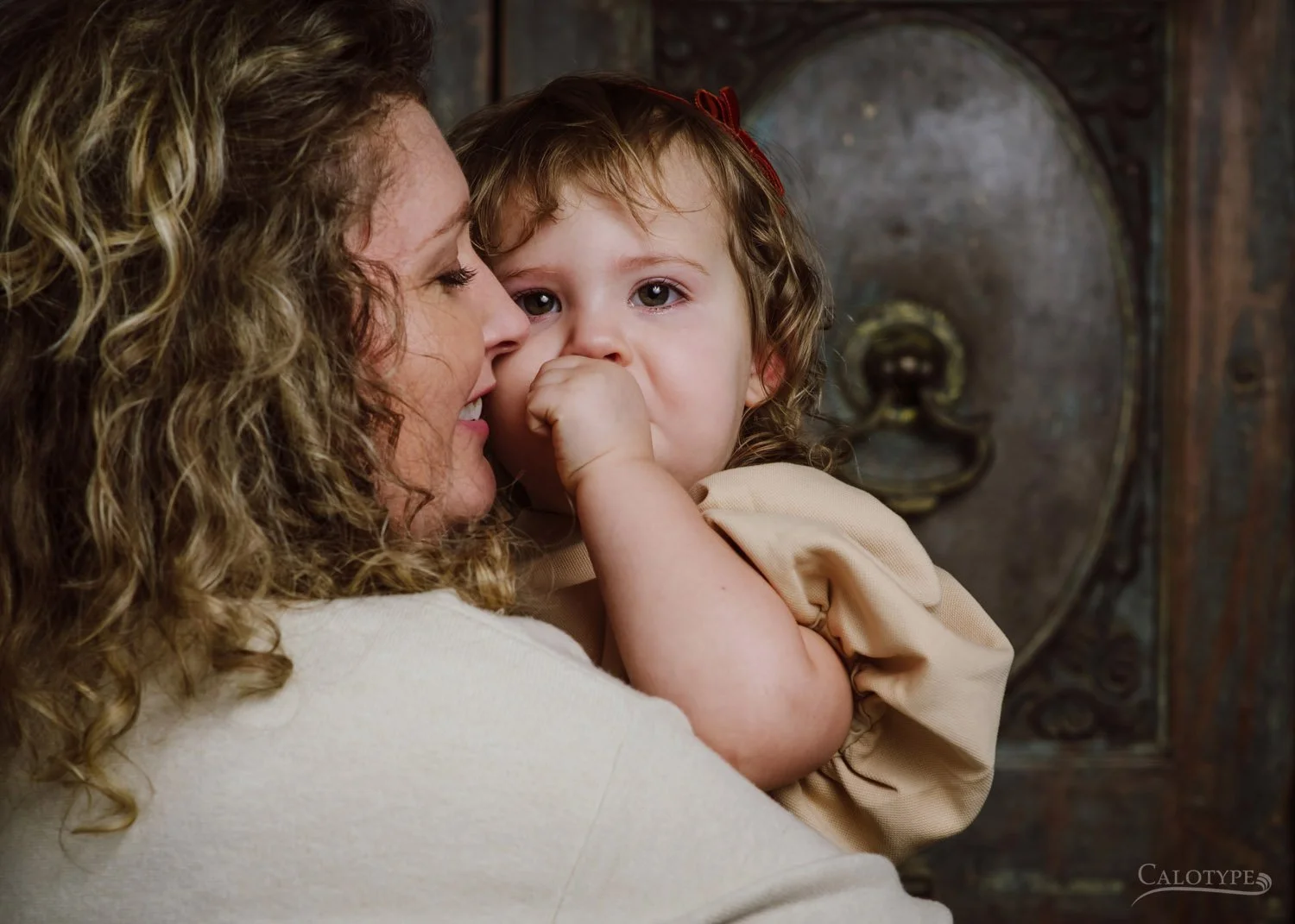 mom comforts crying toddler daughter