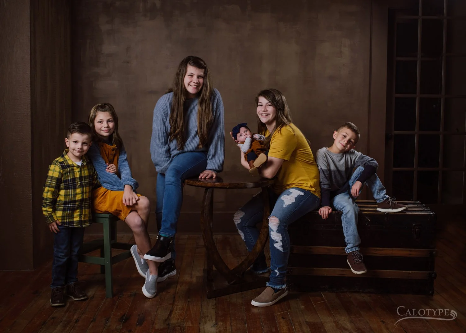 group photo of six cousins ranging from newborn to  13