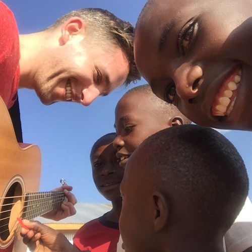  Playing music with children at the Tumaini Innovation Center. I hold the chords, and they strum.