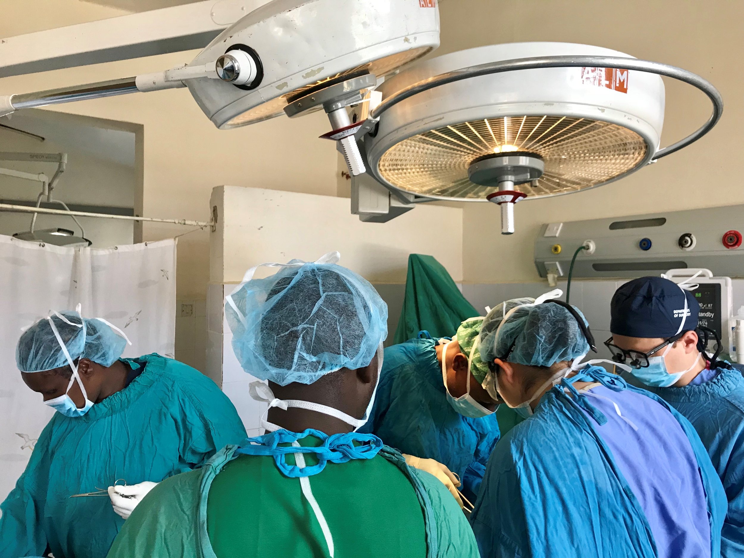 Dr. Connie Keung (AMPATH Surgery Team Lead) and Dr. Kyle Carpenter (Global Surgery Fellow and IU Surgery Resident) conducting a surgery in conjunction with Kenyan surgical counterparts in Eldoret, Kenya.