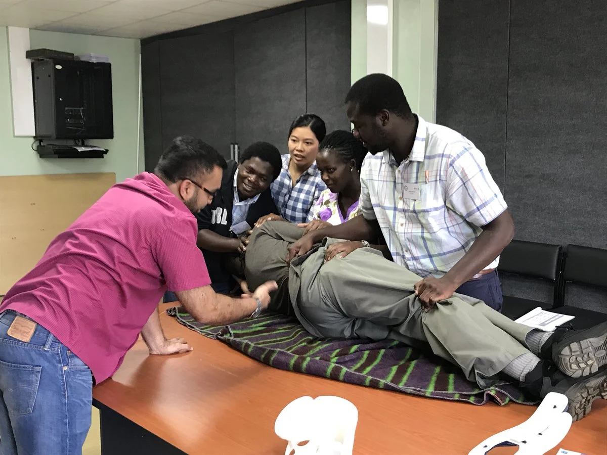 Learning the proper leg rolling and neck collar techniques at ATLS training.