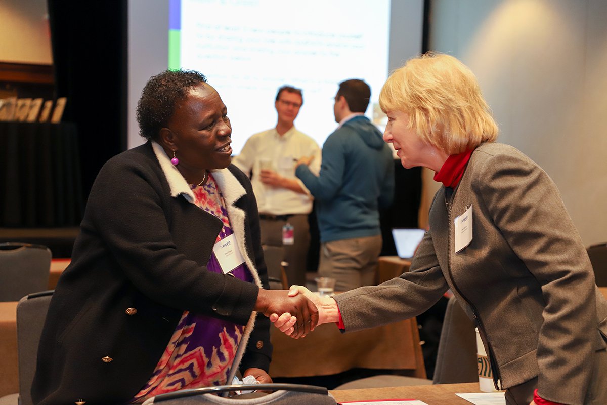  Dean of the Moi University School of Nursing, Dr. Dinah Chelagat, and Dr. Deb Litzelman, Director of Education for the IU Center for Global Health, greet each other at the AMPATH Consortium meeting.  