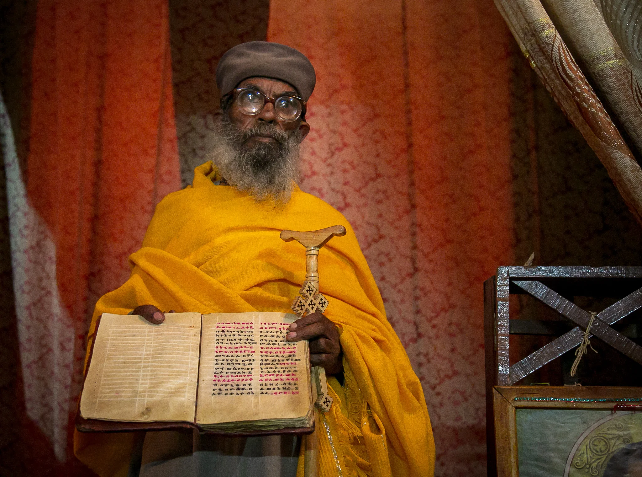 Inside, the priest displays an ancient parchment of scriptures in the Amharic language, hand-copied a hundred years before the Bible was translated into English. // photo © Kim I. Mott