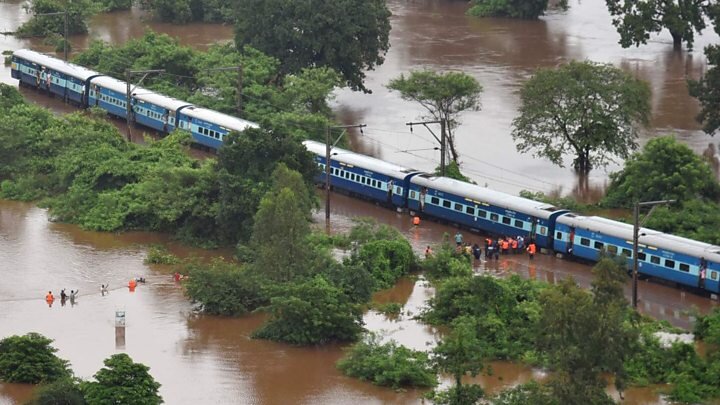  An Indian railways train stuck midway due to rising flood levels, while the NDRF rescue passangers 