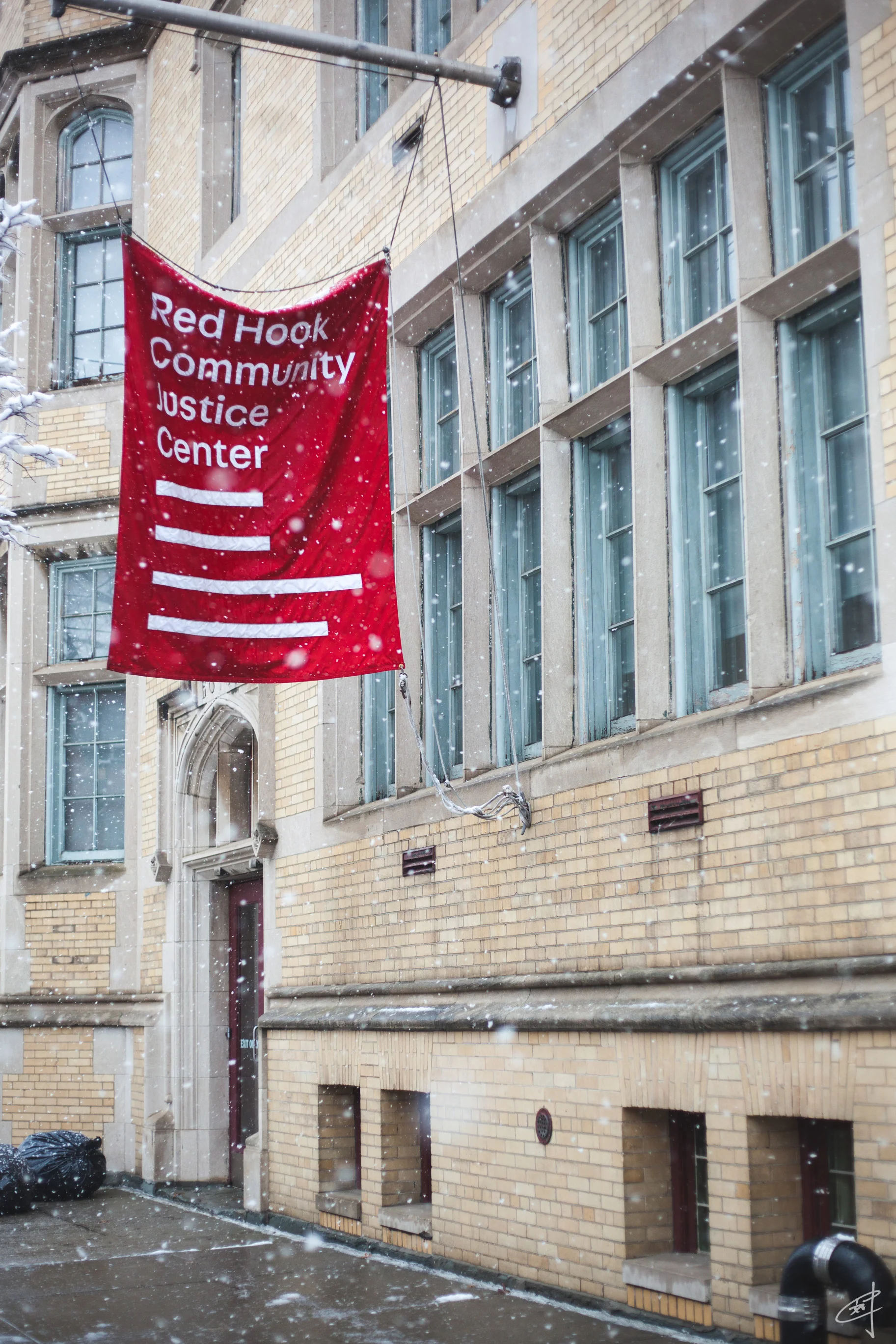 The banner outside Red Hook Community Justice Center on a snowy, spring morning.