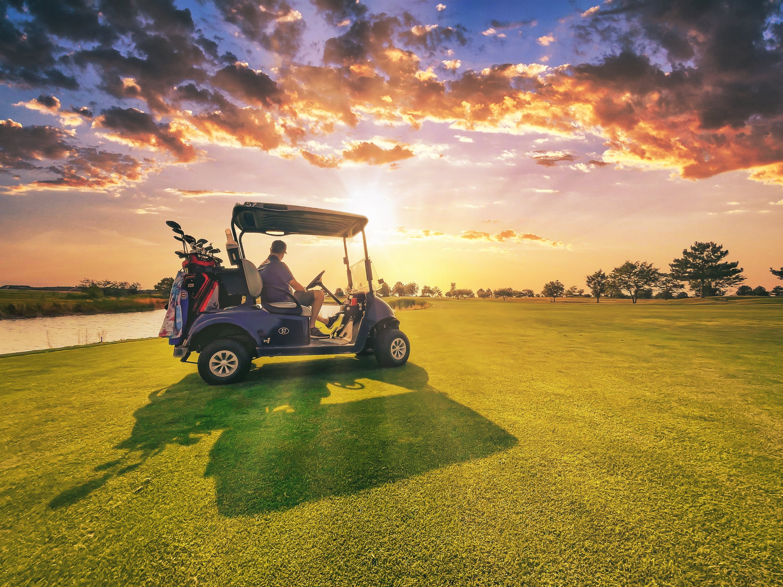 TIM IN CART FALCON CREST GOLF BOISE SUNSET.jpeg