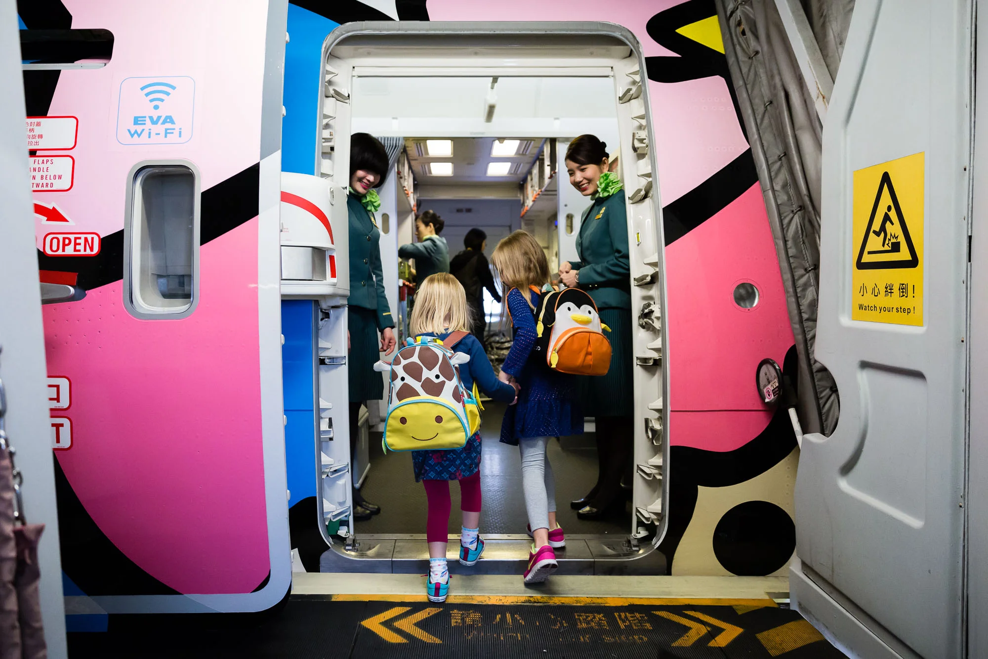 two-sisters-boarding-eva-airlines-airplane-in-taipei-by-rebecca-hunnicutt-farren-photography