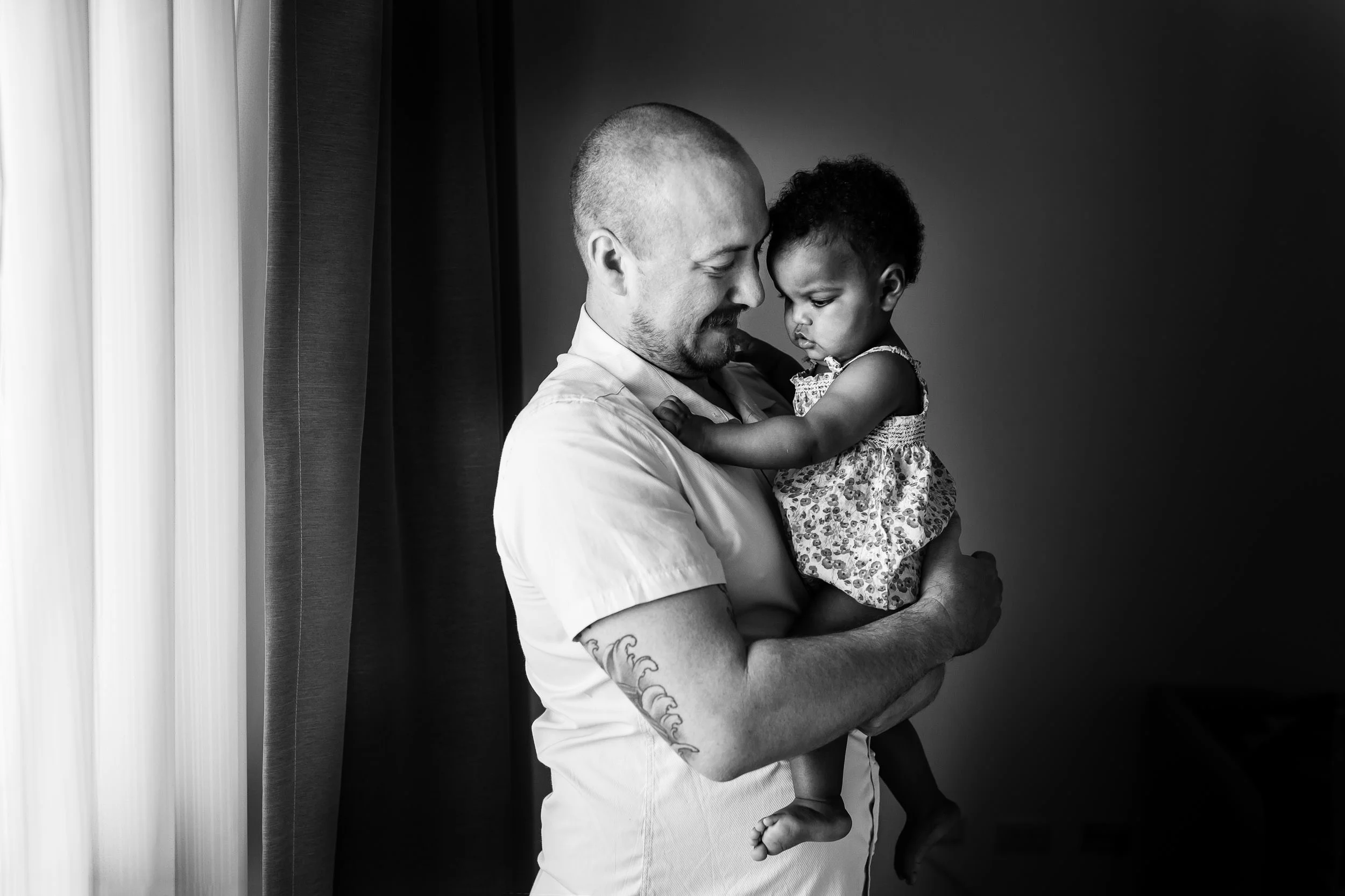 monochrome_image_of_father_and_daughter_cuddling_by_window_by_Hunnicutt_Photography-332.jpg