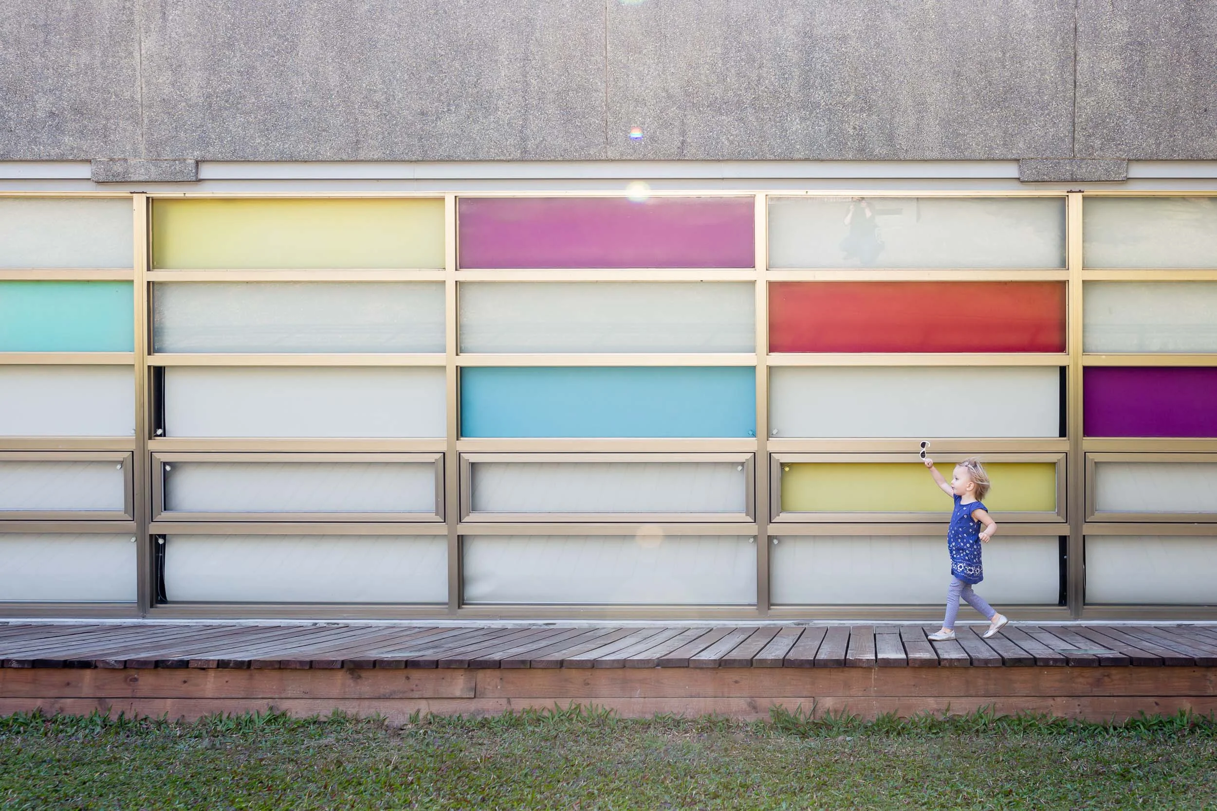 girl_running_by_colored_windows_holding_sunglasses_Personal_portfolio_by_rebecca_hunnicutt_farren.jpg