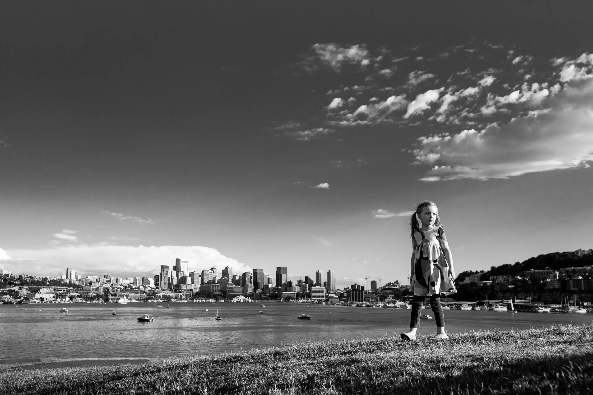monochrome_image_of_girl_walking_with_seattle_skyline_in_background_Personal_portfolio_by_rebecca_hunnicutt_farren.jpg