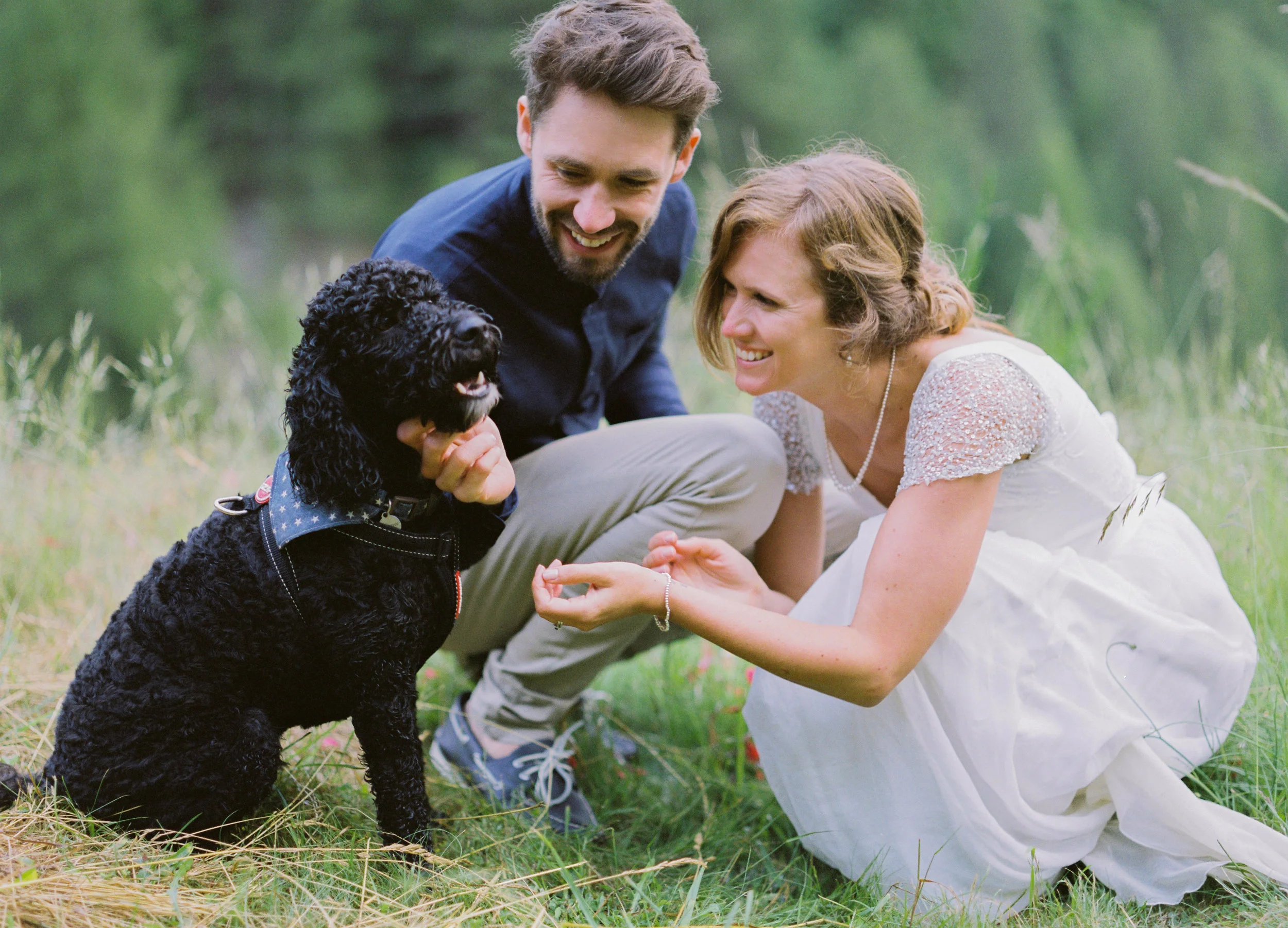 married couple dote on dog on wedding day