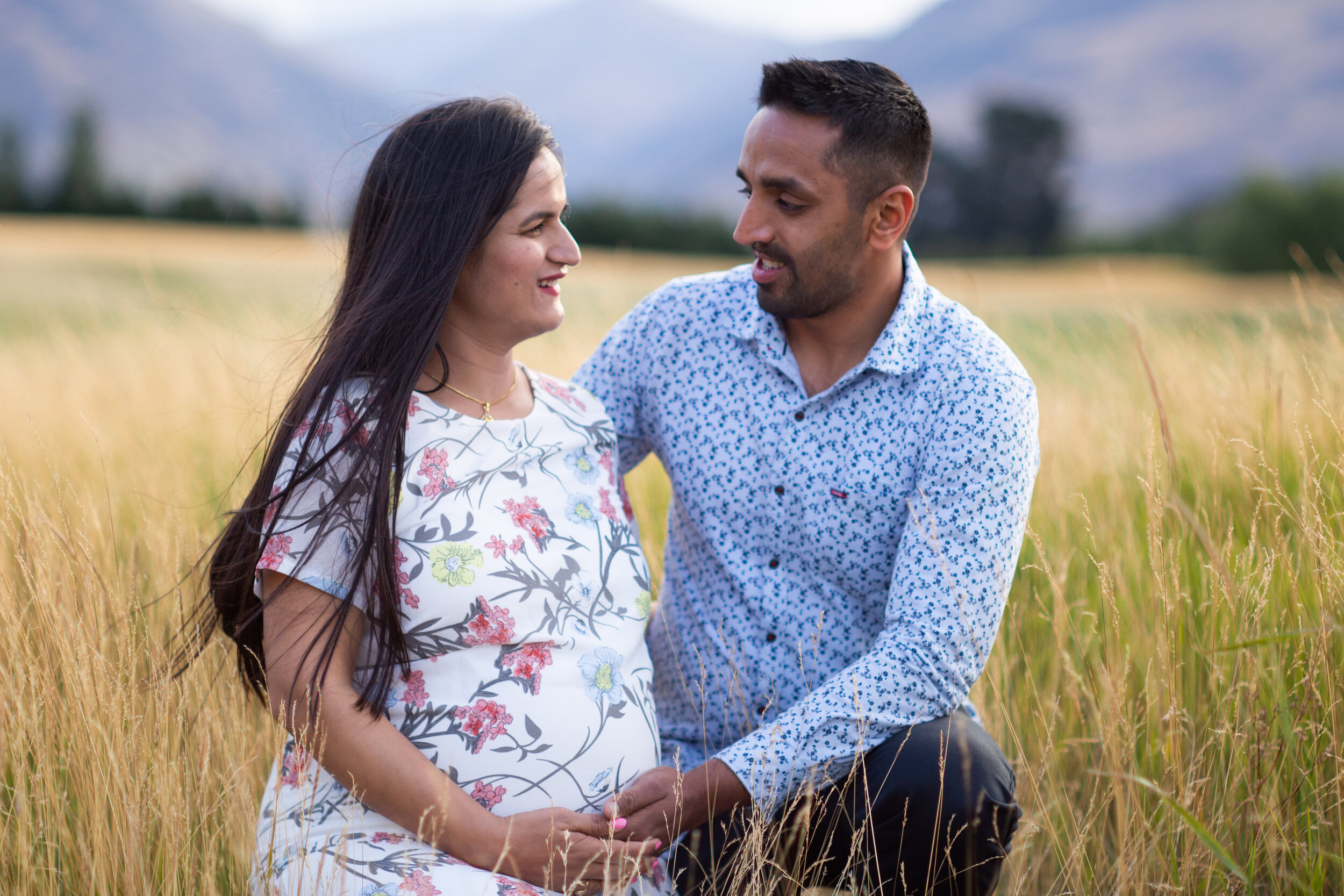 Expectant parents hold baby bump