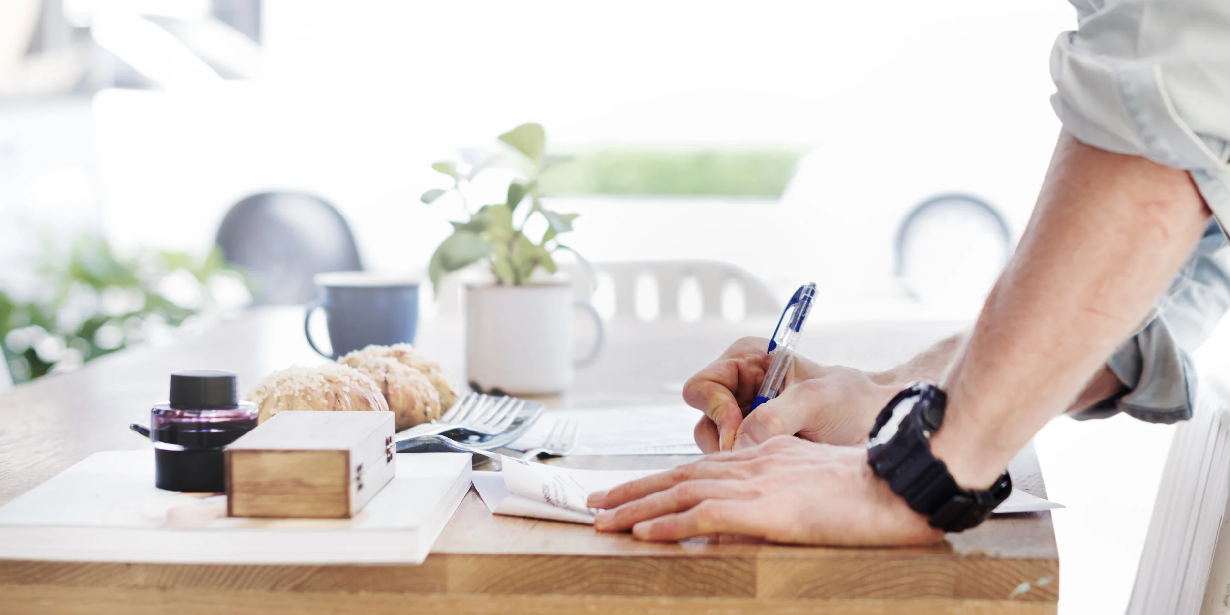 Man writing at desk