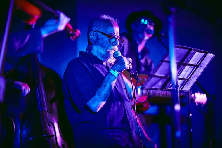 Chuck Auerbach at the Driskill on March 17th, 2018. Koury Angelo one of the 30 best artists at SXSW The sons and daughters of music celebrities often work the halls and stages of SXSW. But Chuck Auerbach of Akron, Ohio was a rare sighting: a rock star's dad. Perched on a stool and consulting a binder of lyric sheets as he sang through a long, gray field of beard, Auerbach – the father of the Black Keys' Dan Auerbach – looked like the late Atlantic Records producer Jerry Wexler and led his five-piece band through rueful country ballads and earthy R&B in a grizzled voice that suggested Tom Waits with a dash of the singer from Dr. Hook and the Medicine Show (the one without the eye patch). "Desperation" was a dark jewel lashed with throaty-treble guitar; the first two verses of "My Old Man" were a memory lane of plaintive growl and upright bass, before the light rain of bittersweet fiddle and electric piano rolled in. Chuck was performing songs from a new album, Remember Me , produced by Dan. (From Rolling Stone )
