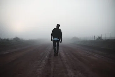 man-walking-away-on-misty-260nw-671168848.jpg