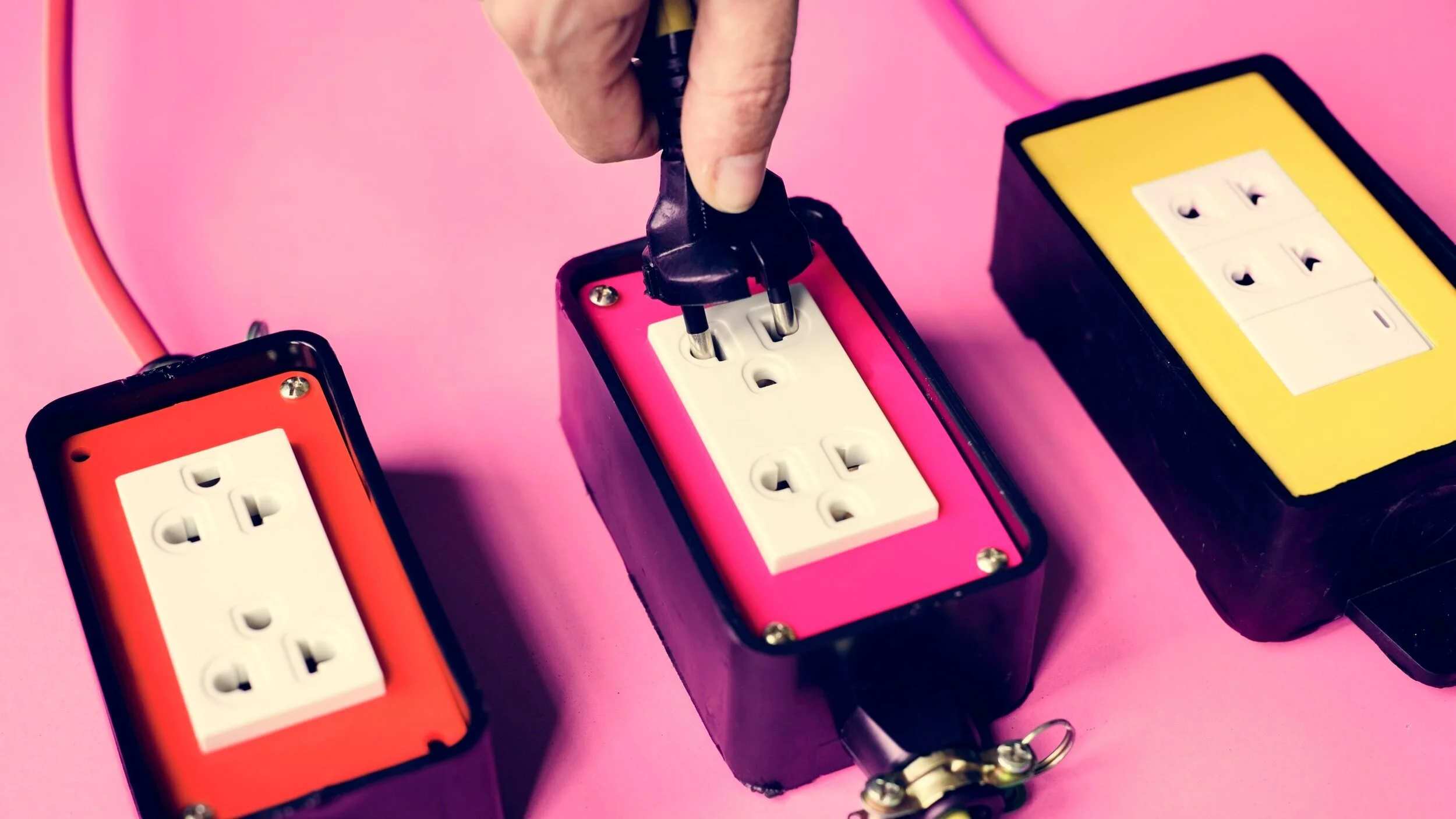 hand-hold-electric-plug-into-the-outlet-PRXJS3L.jpg