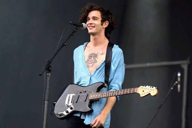 Healy on stage wearing what is definitely a ladies shirt (note the side the buttons fall on) Source: REX USA