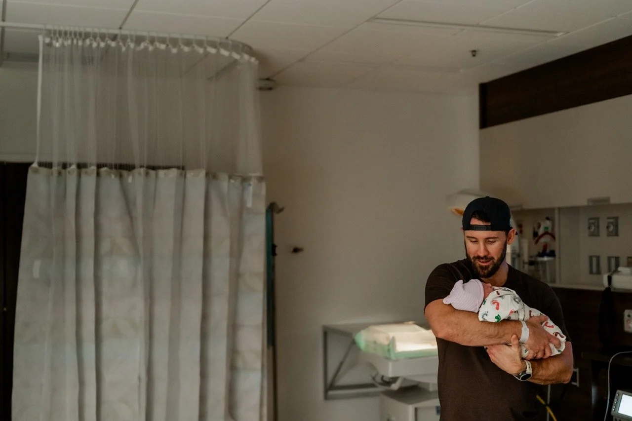 Father holding his baby daughter for the first time at Piedmont Hospital