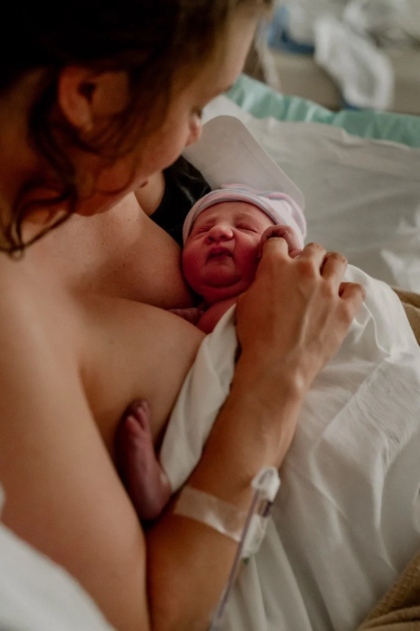 Mom holding her newborn baby in the hospital bed at Piedmont Hospital Atlanta